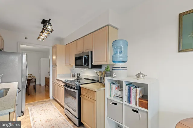 a view of a kitchen from a hallway