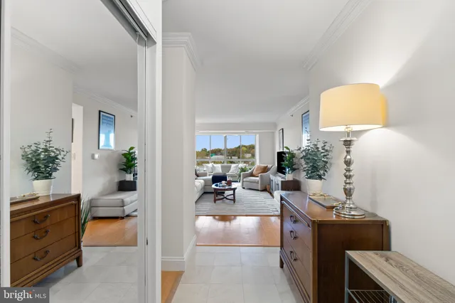 a living room with furniture a rug and a book shelf