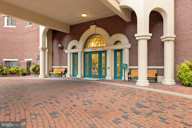 a view of a brick house with large windows
