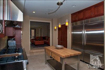 905 Mandalay Beach Road Oxnard, CA 93035 - Photo 17 of 30 a kitchen with stainless steel appliances kitchen island granite countertop a refrigerator and a stove