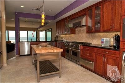 905 Mandalay Beach Road Oxnard, CA 93035 - Photo 18 of 30 a kitchen with stainless steel appliances granite countertop a stove a sink and a microwave
