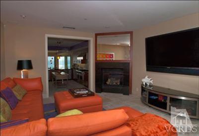 905 Mandalay Beach Road Oxnard, CA 93035 - Photo 20 of 30 a living room with furniture a flat screen tv and a fireplace