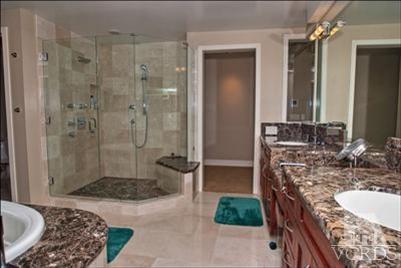 905 Mandalay Beach Road Oxnard, CA 93035 - Photo 23 of 30 a bathroom with a double vanity sink a toilet a mirror and shower
