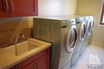905 Mandalay Beach Road Oxnard, CA 93035 - Photo 4 of 30 a bathroom with a sink and a washer dryer