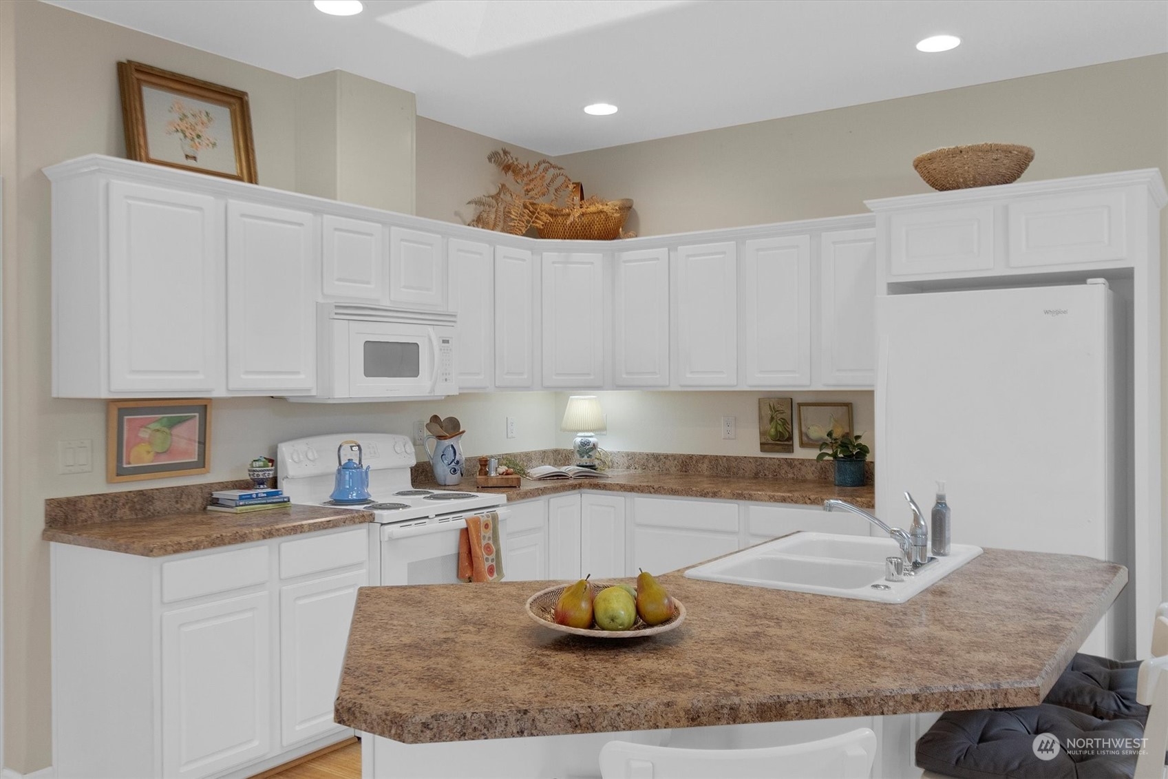 112 Willow Pointe Loop, Unit 112 Longview, WA 98632 - Photo 7 of 21 a kitchen with kitchen island granite countertop a sink a stove and white cabinets