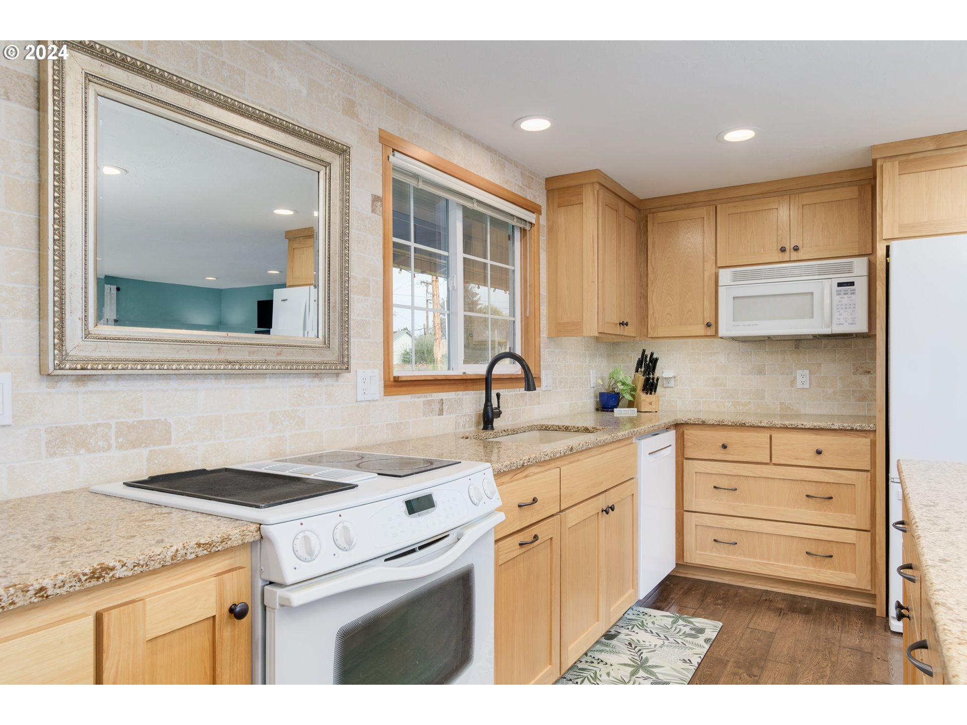 3456 Tempa Street Eugene, OR 97404 - Photo 11 of 48 a kitchen with granite countertop cabinets stainless steel appliances and a sink