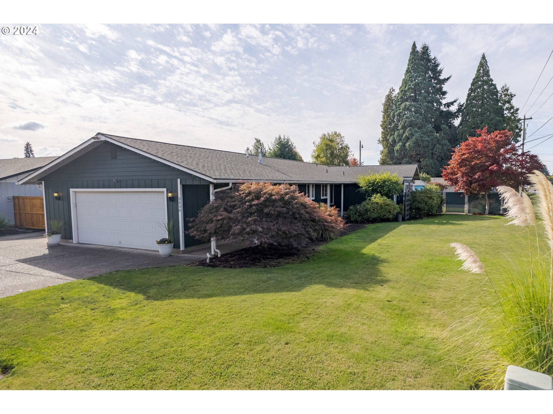 3456 Tempa Street Eugene, OR 97404 - Photo 44 of 48 a view of a house with a swimming pool and a yard