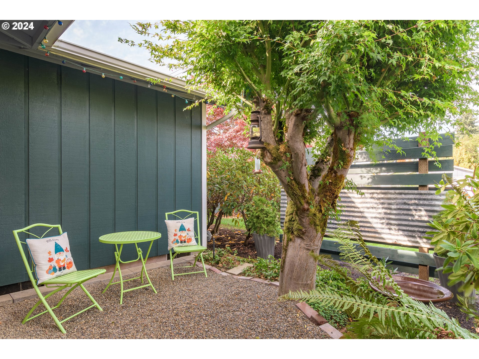 3456 Tempa Street Eugene, OR 97404 - Photo 5 of 48 a backyard with table and chairs and potted plants