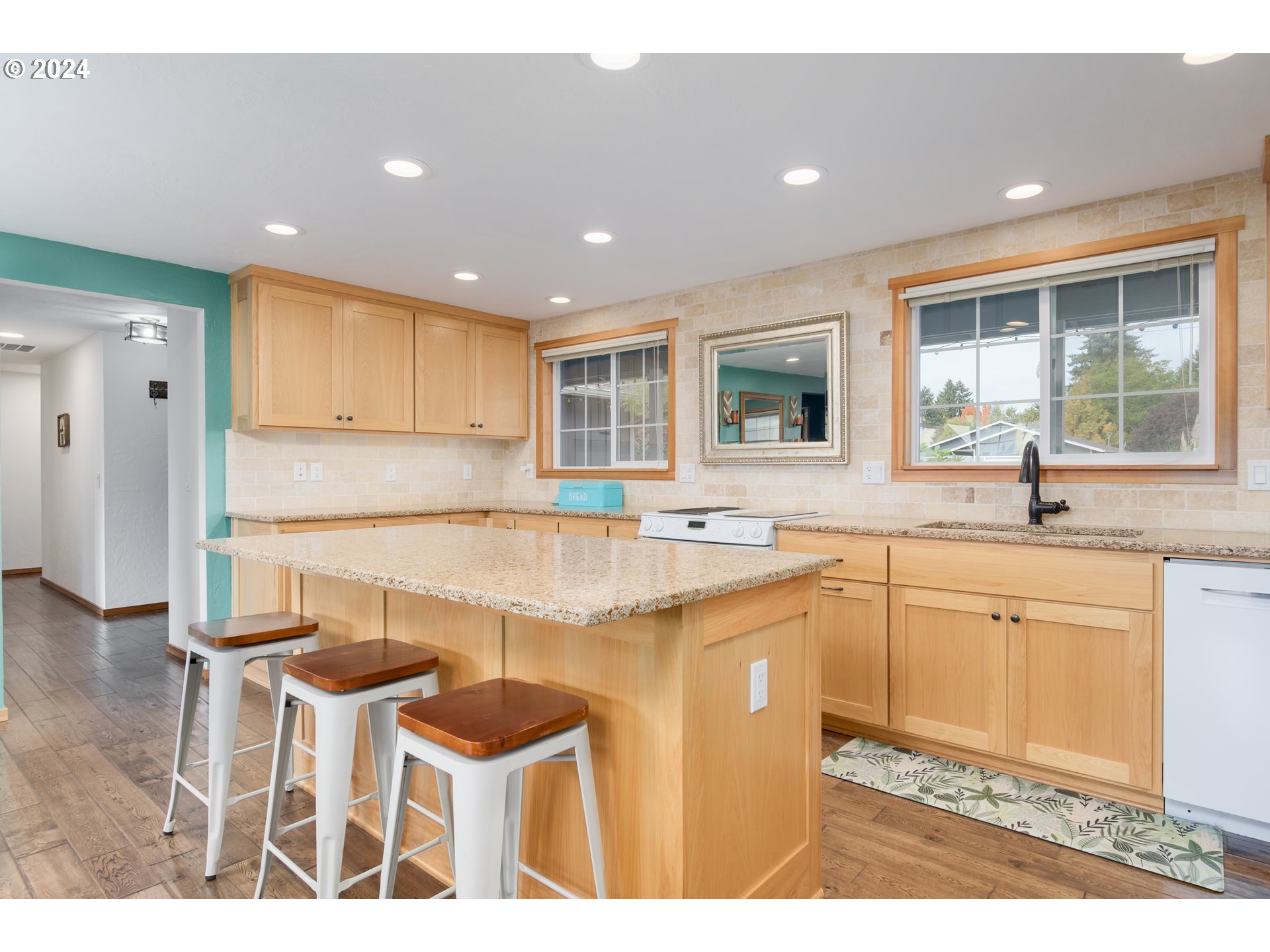3456 Tempa Street Eugene, OR 97404 - Photo 10 of 48 a open kitchen with granite countertop a sink and white cabinets