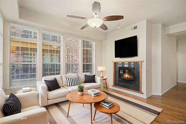 a living room with furniture a fireplace and a flat screen tv