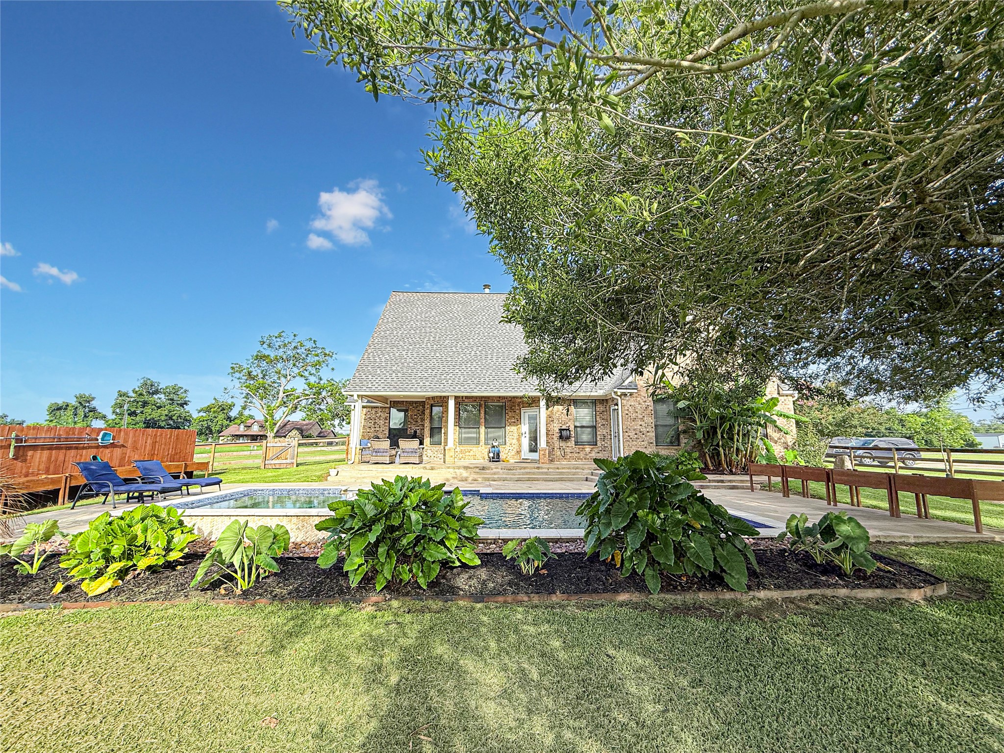 807 Mill Road Angleton, TX 77515 - Photo 36 of 46 Lush landscaping creates a private poolside retreat.