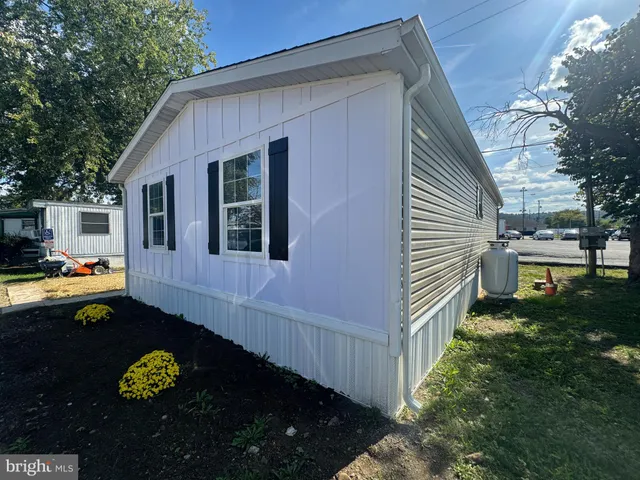 a front view of a house with yard and trees