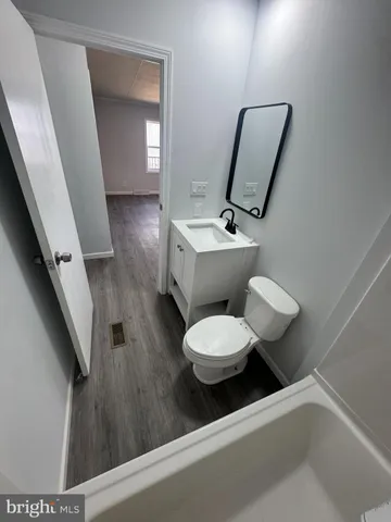 a bathroom with a toilet sink and mirror