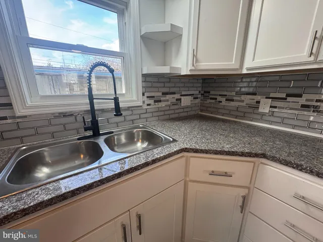 a kitchen with sink and cabinets