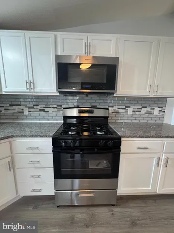a kitchen with a stove and a microwave