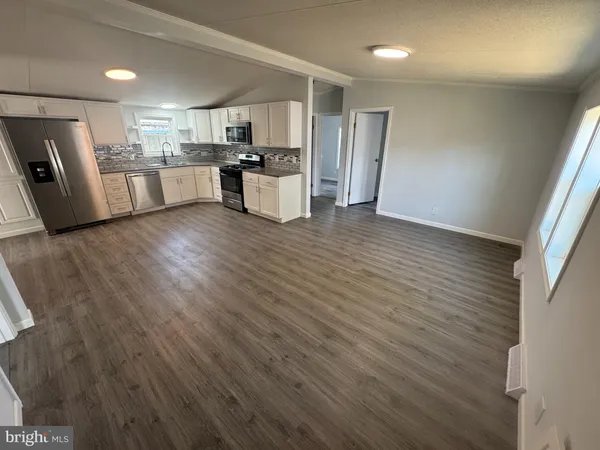 a kitchen with stainless steel appliances a refrigerator sink and microwave