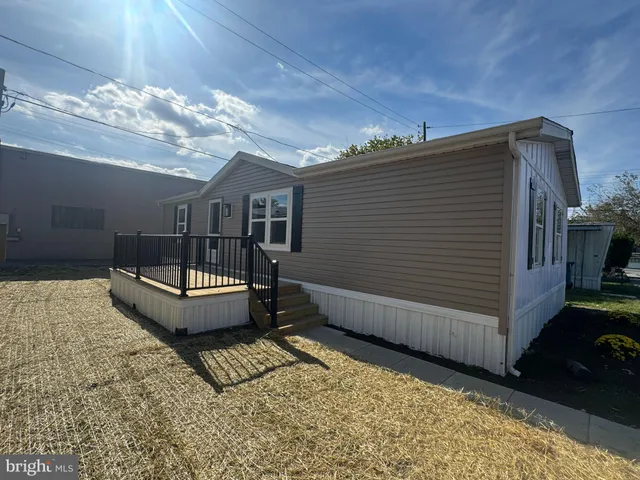 a spacious bedroom with a bed and a chandelier