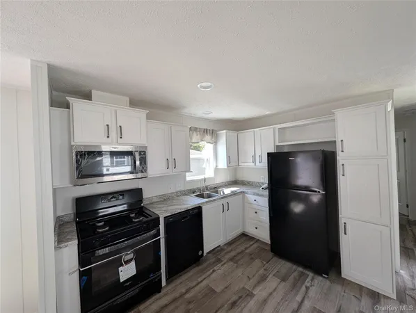 a kitchen with a refrigerator stove and sink