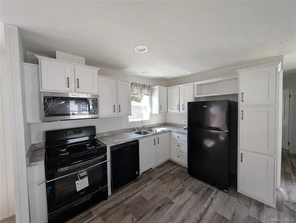 a kitchen with a refrigerator and a stove top oven
