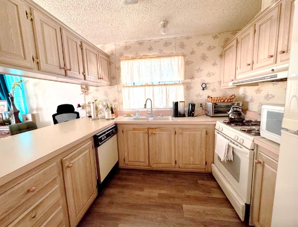 55 Pacifica Avenue, Unit 90 Bay Point, CA 94565 - Photo 2 of 11 a kitchen with sink a stove and cabinets