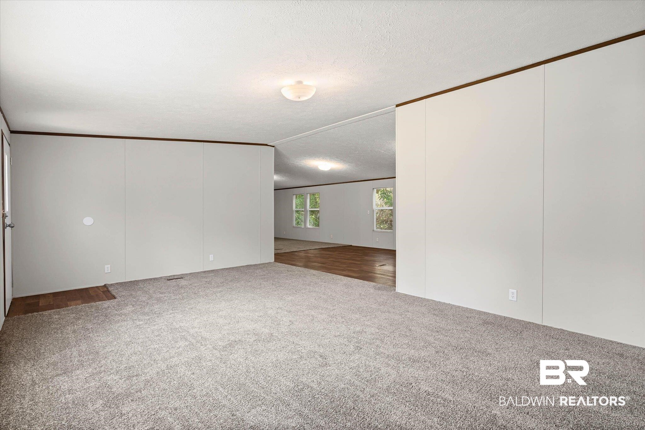 25366 Pollard Road Daphne, AL 36526 - Photo 3 of 22 Spacious interior featuring neutral carpeting and light-toned walls
