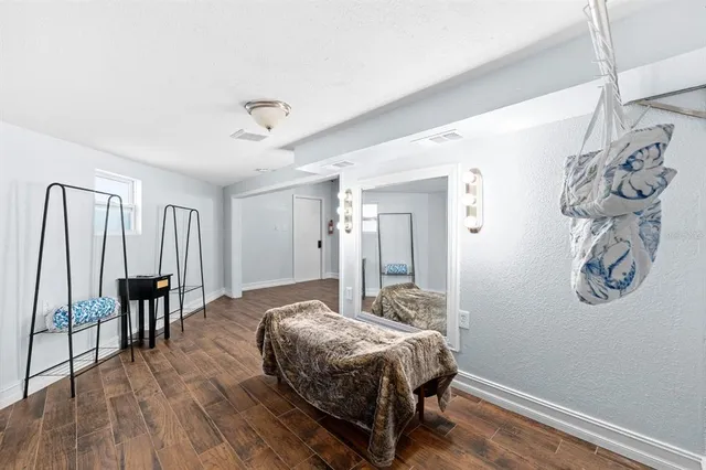 a spacious bedroom with a bed and a table in it