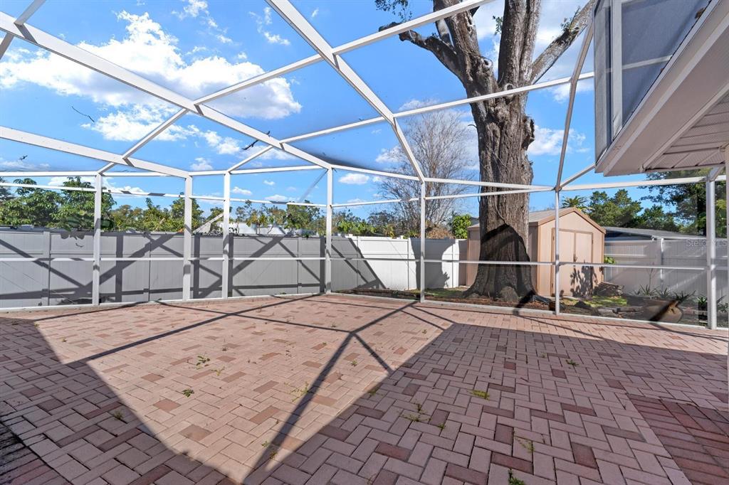 8644 May Circle Tampa, FL 33614 - Photo 18 of 28 a view of a backyard with table and chairs under an umbrella