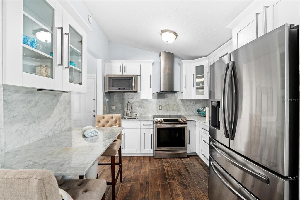 8644 May Circle Tampa, FL 33614 - Photo 7 of 28 a kitchen with stainless steel appliances granite countertop a refrigerator stove and sink