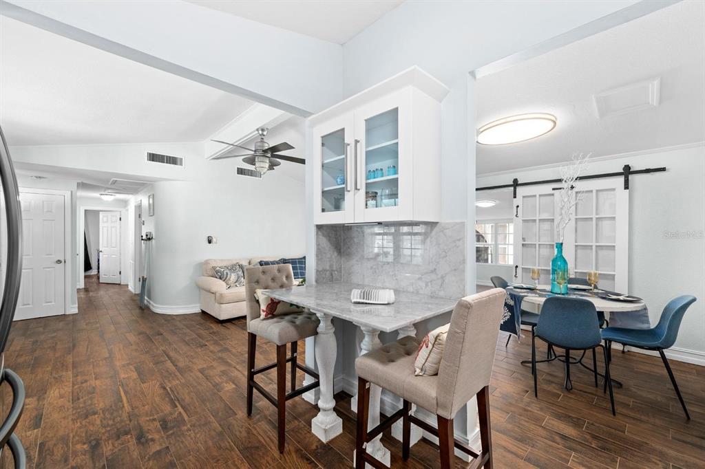 8644 May Circle Tampa, FL 33614 - Photo 8 of 28 a view of a dining room with furniture and wooden floor