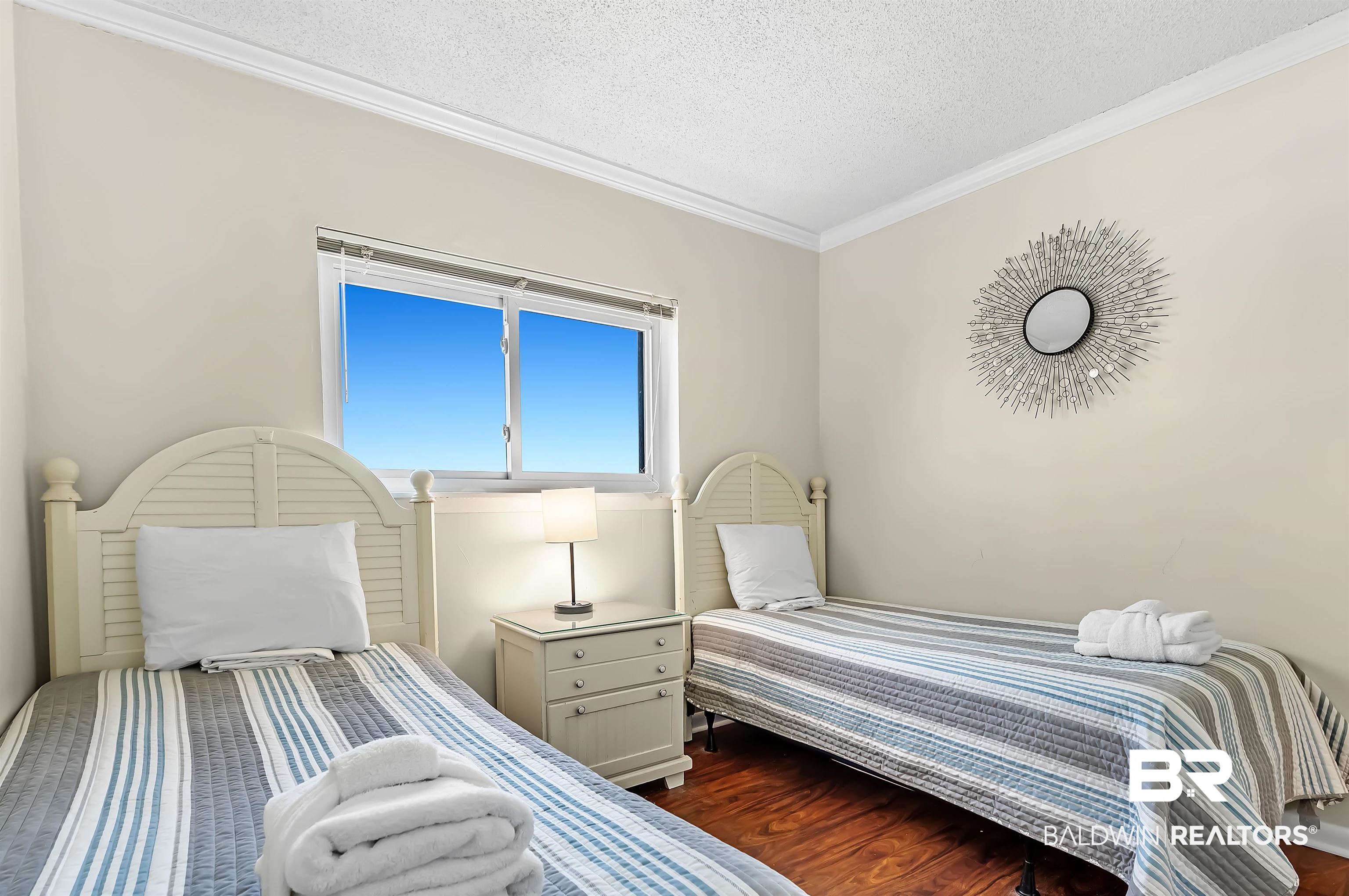 375 Plantation Road, Unit 5409 Gulf Shores, AL 36542 - Photo 24 of 48 Bedroom with a textured ceiling, crown molding, and dark hardwood / wood-style floors