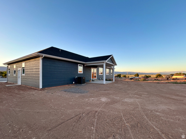 6 South 450th West Gunnison, UT 84634 - Photo 5 of 45 Modern residence featuring dark blue siding, white trim, and a covered patio area