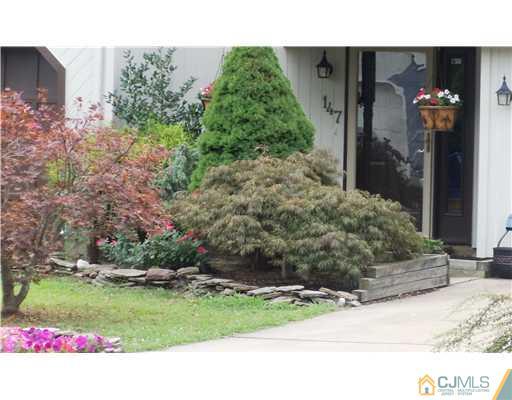 147 Redpine Loop Old Bridge, NJ 08857 - Photo 1 of 25 a front view of a house with a yard