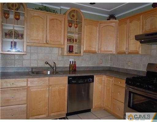 147 Redpine Loop Old Bridge, NJ 08857 - Photo 11 of 25 a kitchen with stainless steel appliances granite countertop a sink stove and cabinets