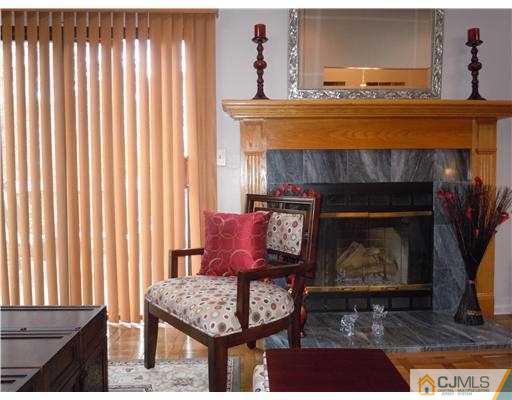 147 Redpine Loop Old Bridge, NJ 08857 - Photo 13 of 25 a living room with furniture and a fireplace
