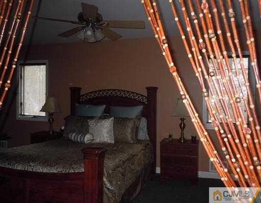 147 Redpine Loop Old Bridge, NJ 08857 - Photo 18 of 25 a bed sitting in a bedroom next to a window