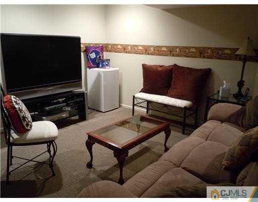 147 Redpine Loop Old Bridge, NJ 08857 - Photo 22 of 25 a living room with furniture and a flat screen tv