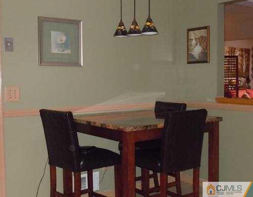 147 Redpine Loop Old Bridge, NJ 08857 - Photo 10 of 25 a view of a dining room with furniture and wooden floor