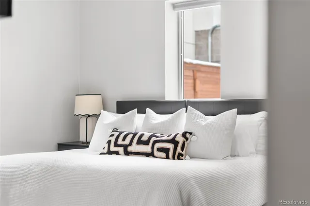 a living room with furniture and glass window