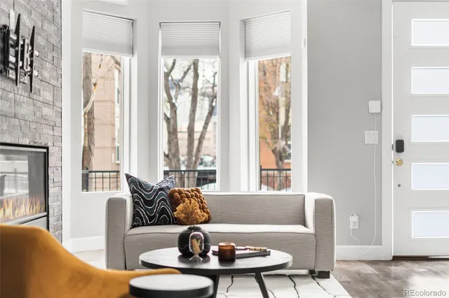 a living room with stainless steel appliances kitchen island granite countertop furniture and a kitchen view