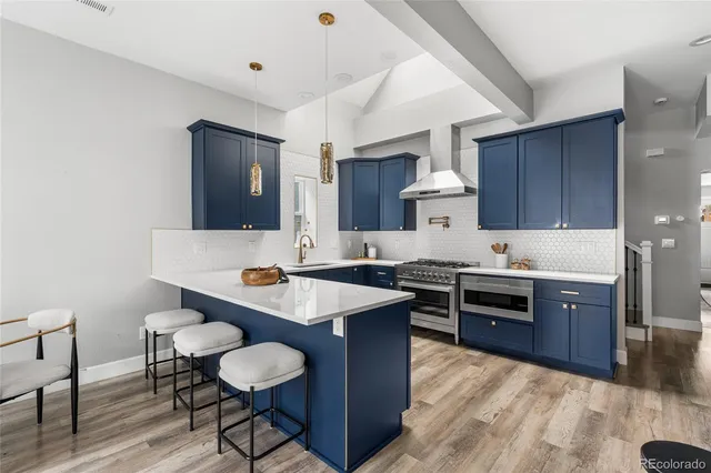 a kitchen with stainless steel appliances granite countertop a sink stove and cabinets