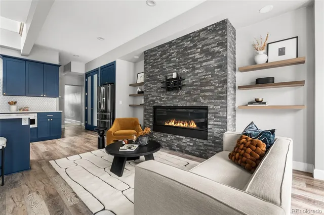 a living room with furniture and a fireplace