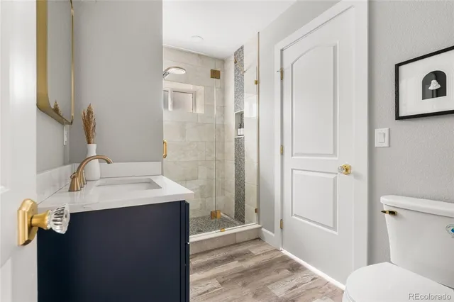 a bathroom with a shower sink and mirror