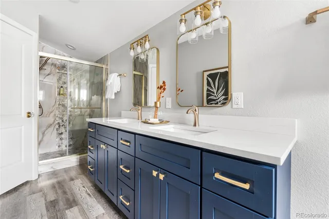 a bathroom with a double vanity sink mirror and bathtub