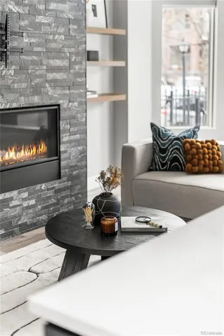 a living room with chairs and a table