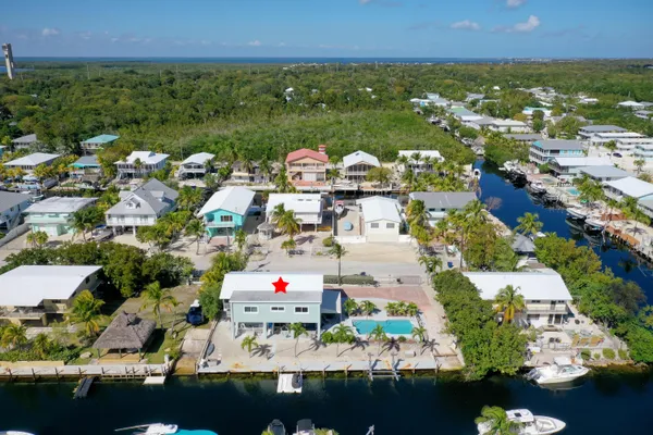 an aerial view of residential houses with outdoor space