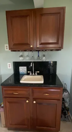 a kitchen with stainless steel appliances granite countertop a sink window and cabinets