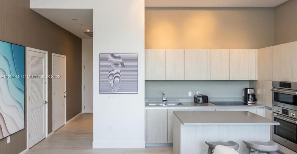 4010 South Ocean Drive, Unit R3106 Hollywood, FL 33019 - Photo 2 of 19 a kitchen with stainless steel appliances granite countertop a refrigerator and a sink