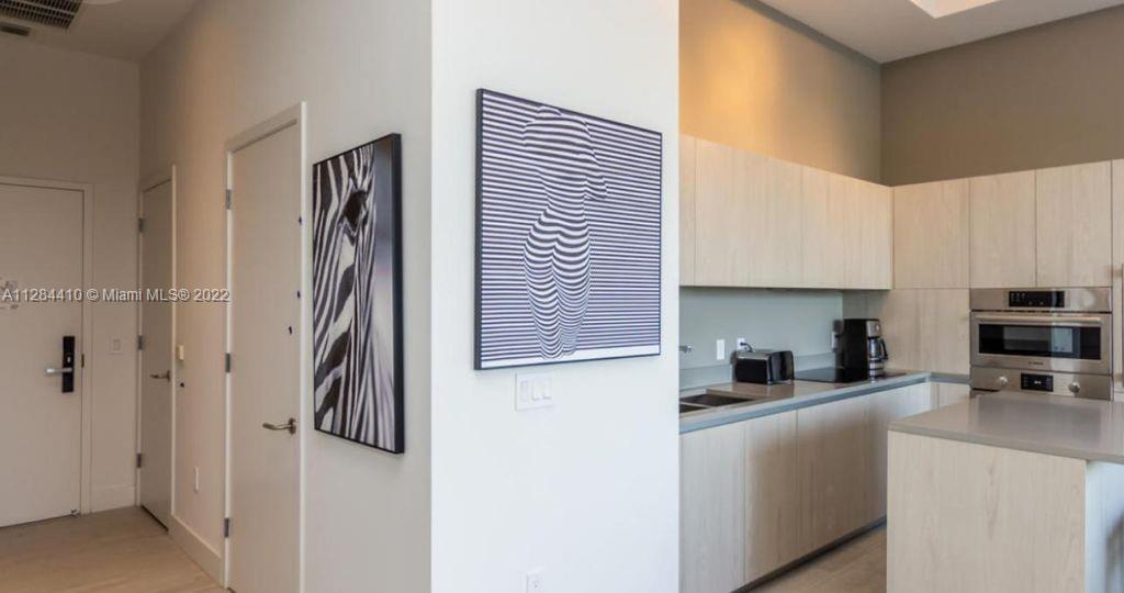 4010 South Ocean Drive, Unit R3106 Hollywood, FL 33019 - Photo 4 of 19 a kitchen with a refrigerator and a sink