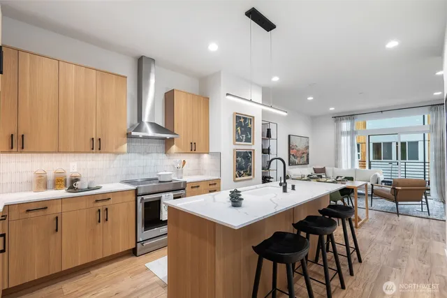 a kitchen with a sink stools a counter space and cabinets