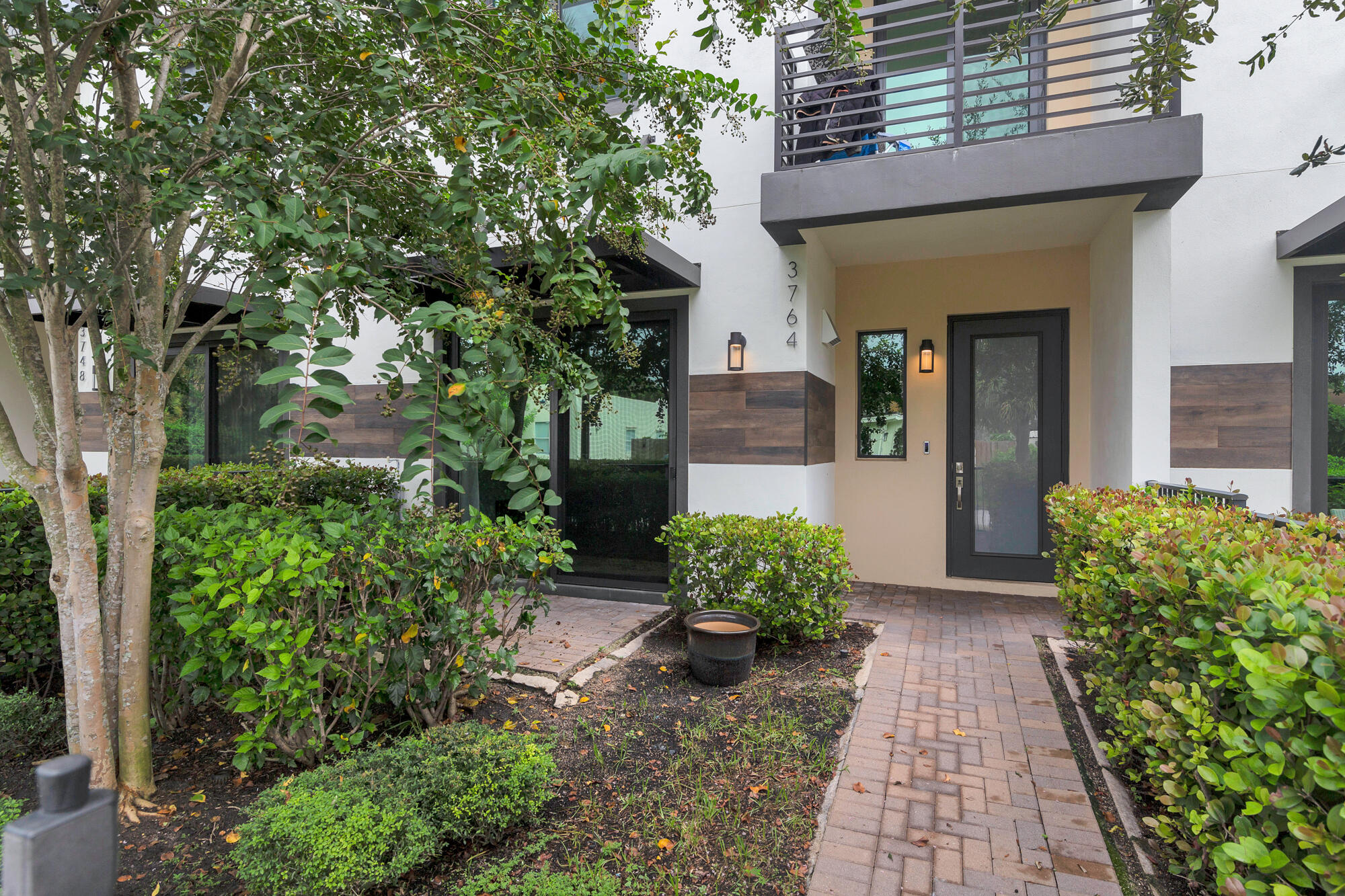3764 Lambert Avenue West Palm Beach, FL 33405 - Photo 2 of 25 a view of a house with potted plants